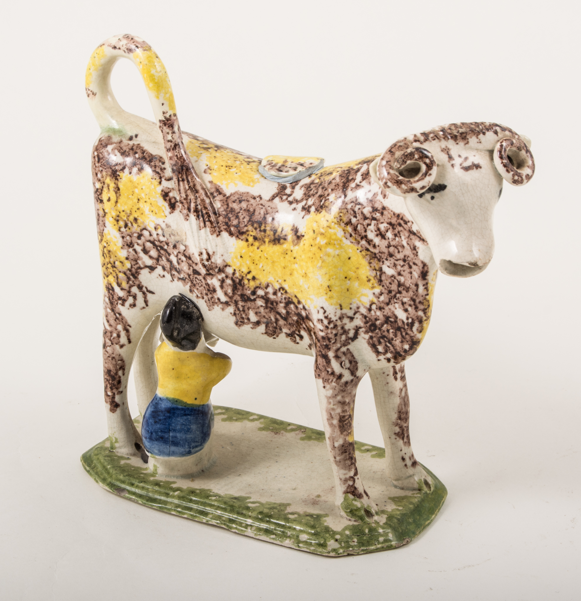 A Prattware type cow and milkmaid creamer, circa 1790,