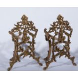 An Edwardian brass fender, moulded curb, shaped rail over, with Rococo scrolls,