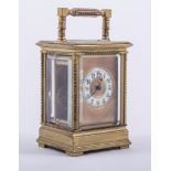 A small French brass cased carriage clock, white enamel chapter ring with Arabic numerals,
