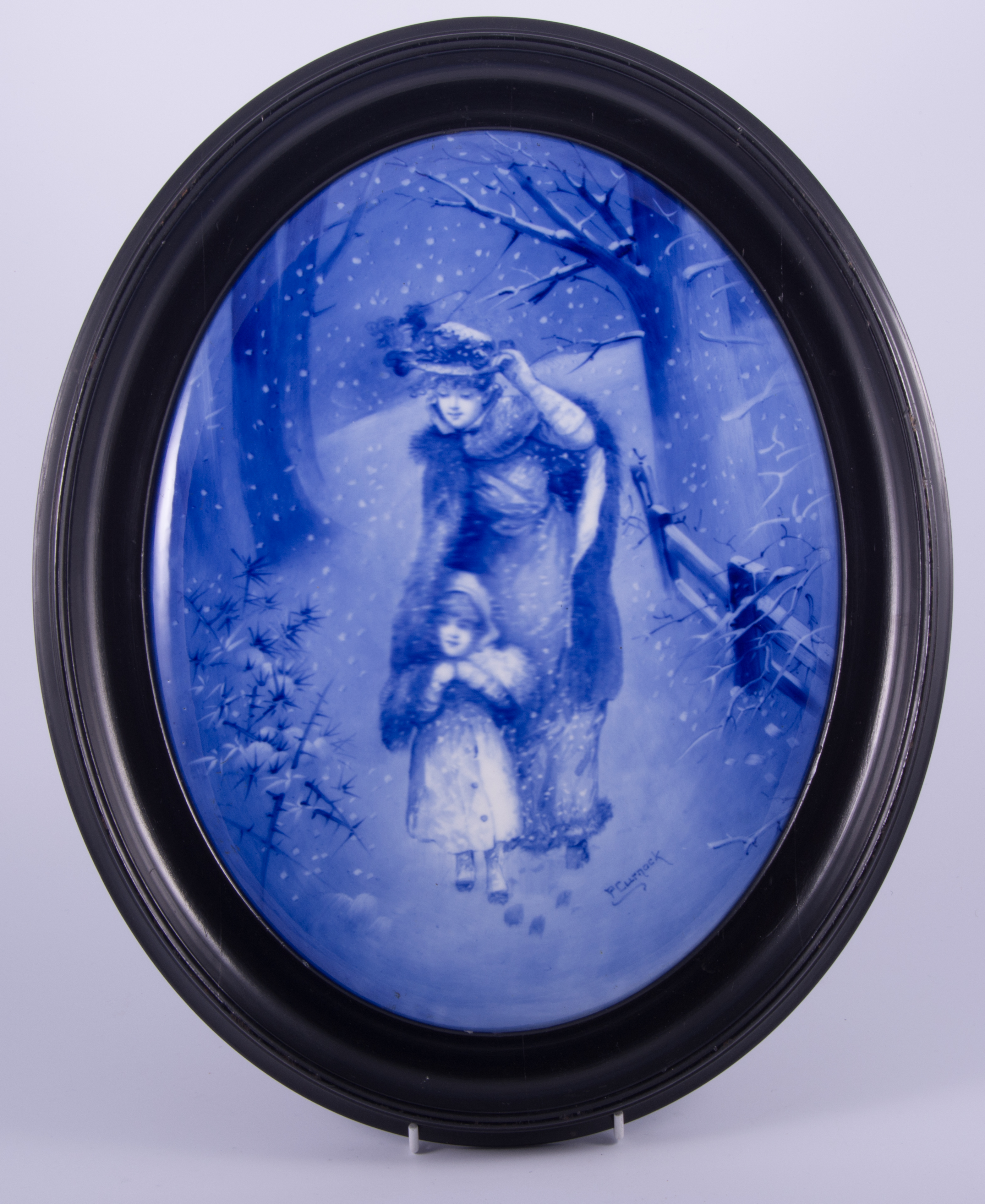 A Doulton Burslem blue and white plaque, 'A Winter's Day', after Percy Curnock, 35cm x 27cm, framed.