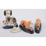 Pair of Staffordshire pen stands modelled with greyhounds,