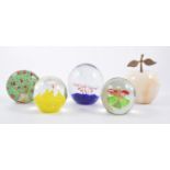 A collection of seventeen glass paperweights.