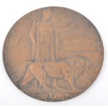 A WWI Bronze Death plaque, named - George Roper, Woolwich Arsenal stamp, 12cm.