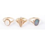 Three opal set rings,