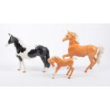 Beswick horse figures; no.1085 Palomino horse, no.1261 Palomino horse, no.1972 Pinto pony, (3).