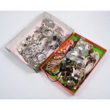 Two boxes of modern costume jewellery - polished white metal necklaces, bangles and bracelets,