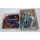 Two boxes of modern costume jewellery - large bead necklaces and bracelets in turquoise, blue,