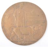 A WWI Bronze Death plaque, named - James Ramsden, Woolwich Arsenal stamp, 12cm.