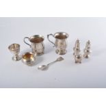 Two small silver christening mugs, a pair of 8cm pepper pots, another small pepper, cauldron salt,