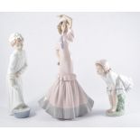 Lladro model, two nuns, No.4611, 33cm, chipped hat; and seven Nao porcelain figures of girls.