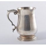 A contemporary silver tankard, plain polished baluster form 13.