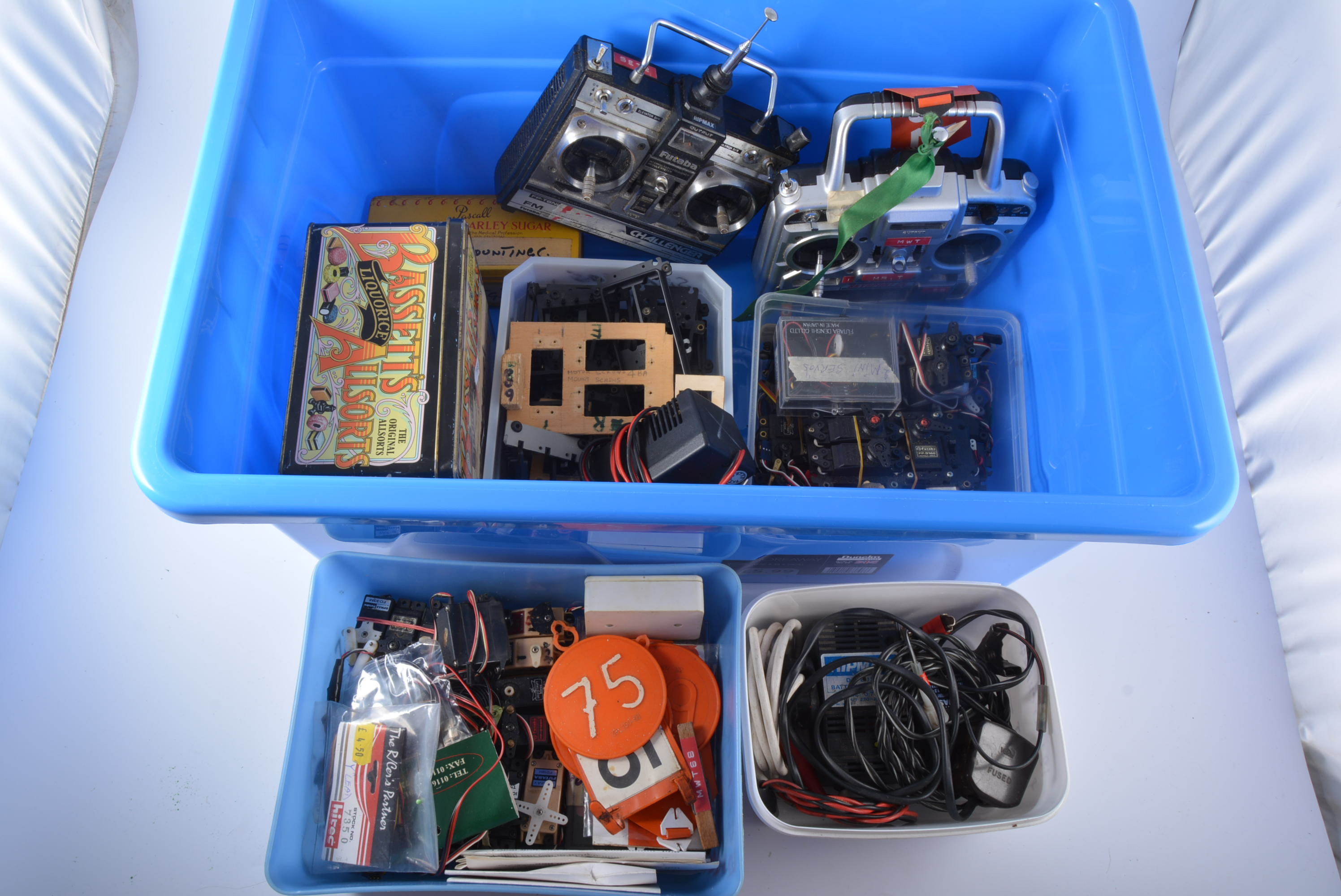 Blue storage box containing FUTABA SKYSPORT 6 TX, box of SERVOS, R/C CHARGERS,