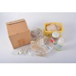 Box containing TISSUE covering material and banded roll of same including box of rubber and timers.