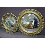 Three gilt framed wall mirrors, two circular convex mirrors 56cm and 44cm diameter,