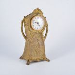 Art Nouveau gilt metal figural mantle clock, the case cast with girl picking fruit,
