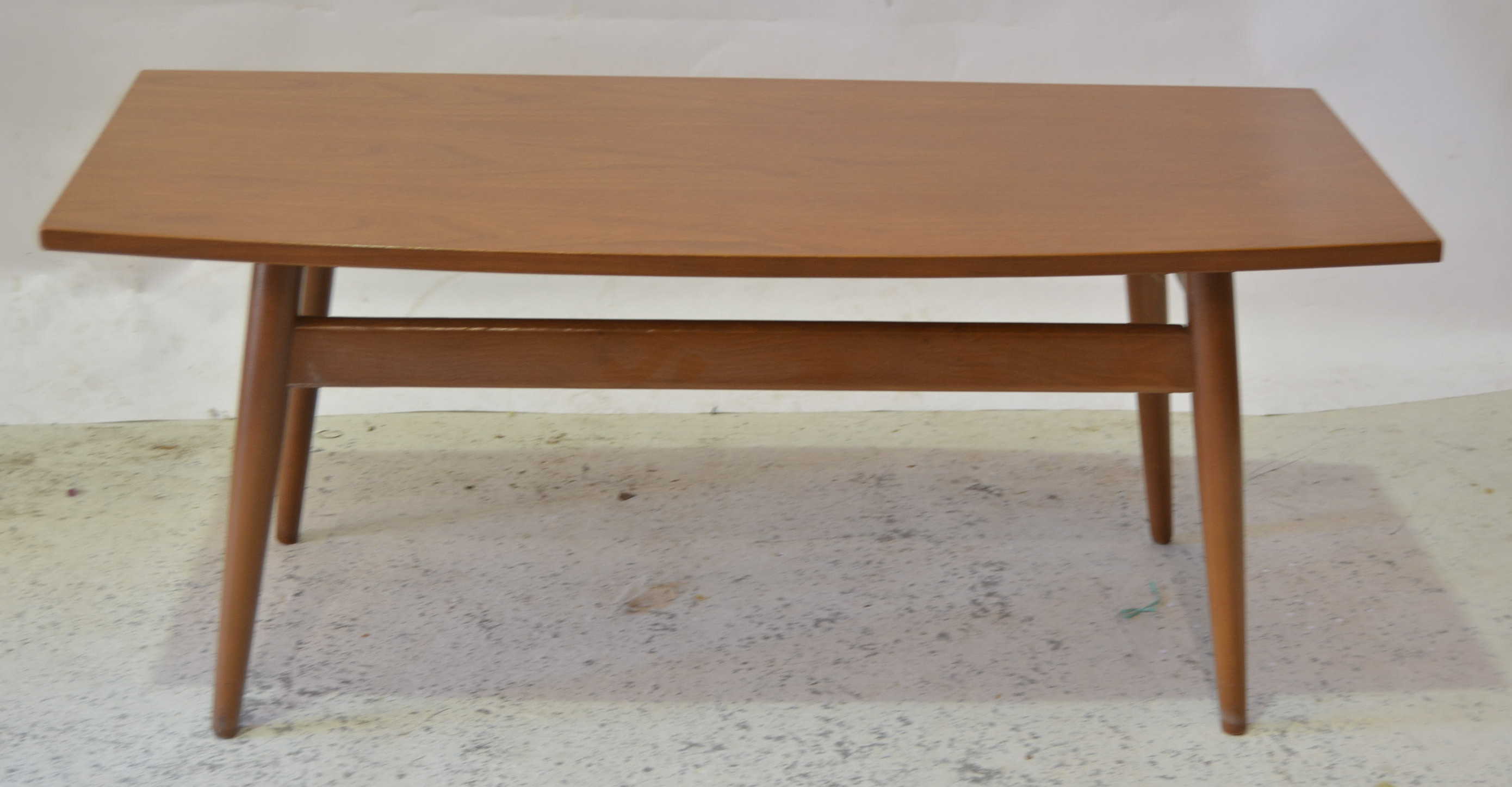 Scandart Limited 1960s teak coffee table, shaped rectangular top on tapered suports,bears label,