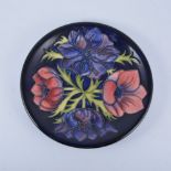 Walter Moorcroft, 'Anemone' plate, 1994, navy ground, 25.5cm diam.