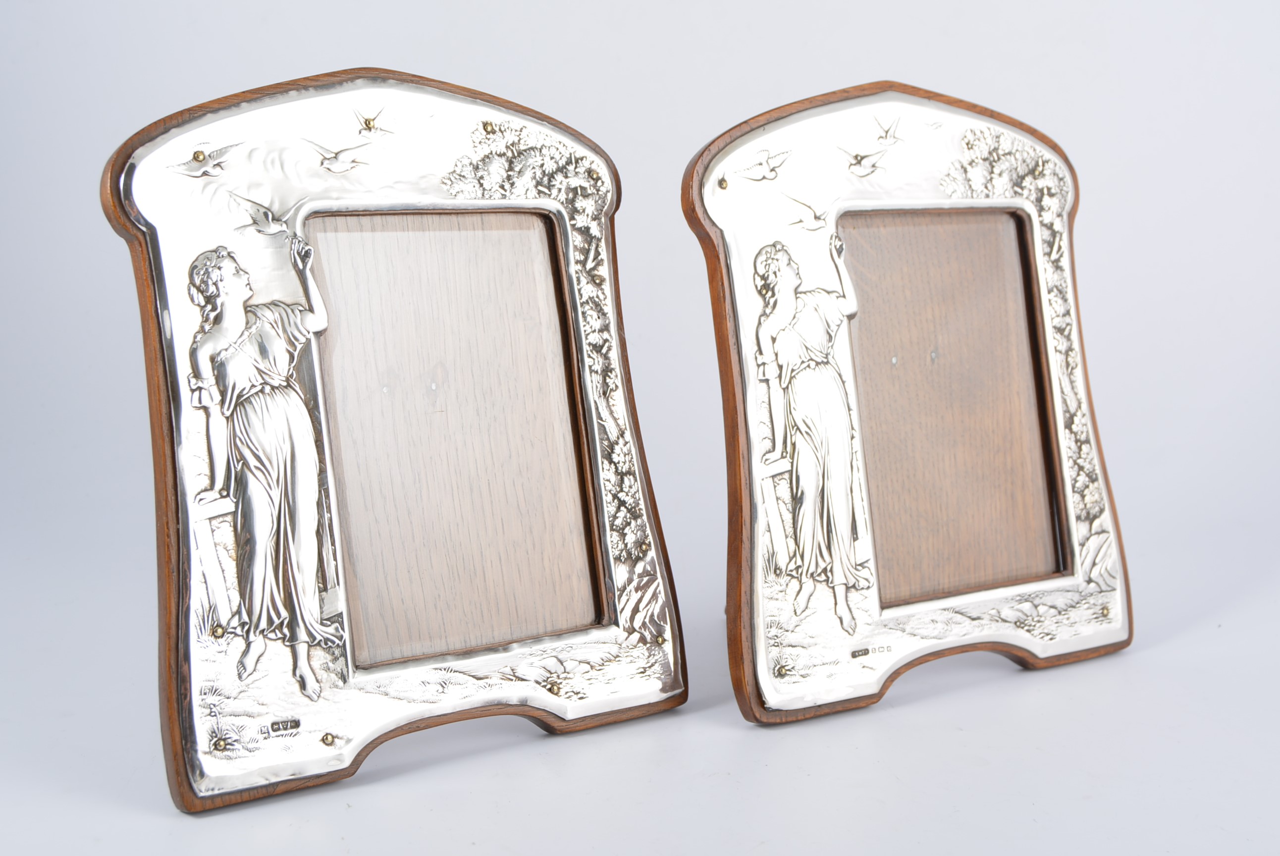 A matched pair of Art Nouveau silver photograph frames,