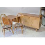 Ercol, a dining room suite, comprising a drop leaf table, four Quaker back Windsor chairs,