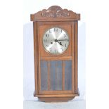 Oak cased wall clock, striking movement, with circular silvered dial, H64cm.