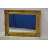 Modern rectangular wall mirror, swept gilt frame, 99 x 73cm.