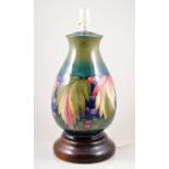 Walter Moorcroft, a large 'Leaf and Berry' table lamp, circa 1950, raised on turned wooden base,