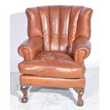 Leather upholstered easy chair, carved legs, ball and claw feet, W84cm.