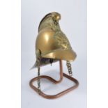 Late Victorian embossed brass fireman's helmet, applied badge with double axe, chain chin strap,