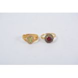 Two dress rings, an oval cluster set with a peridot to centre and surrounded by seed pearls,