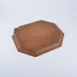 Robert "Mouseman" Thompson of Kilburn, an adzed oak breadboard, octagonal form, 30cm x 25cm.