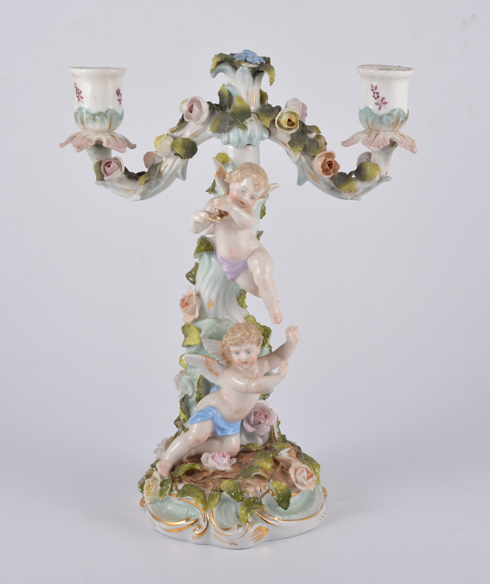 Sitzendorf porcelain two light candelabra, rose encrusted branches, column modelled with cherubs,