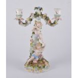 Sitzendorf porcelain two light candelabra, rose encrusted branches, column modelled with cherubs,