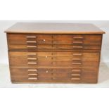 Large oak plan chest, in three sections comprising nine drawers, W151cm x D93cm x H89cm.