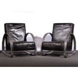 A pair of leather and chrome easy chairs, in the manner of KEM Weber,