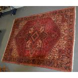 Large Persian pattern carpet, central lozenge medallion on a patterned red ground,