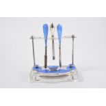 A silver and blue enamel part manicure set on stand, by Albert Carter, Birmingham, 1927-28,