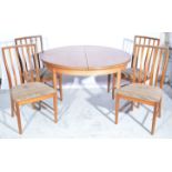 G-Plan extending teak dining table and four slat back chairs,