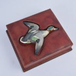 Stitched maroon leather cigar box, the cover inset with a pottery model of a flying duck,