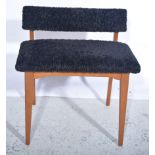 Black upholstered low profile hall chair, and a 1960s upholstered work box raised on teak supports,