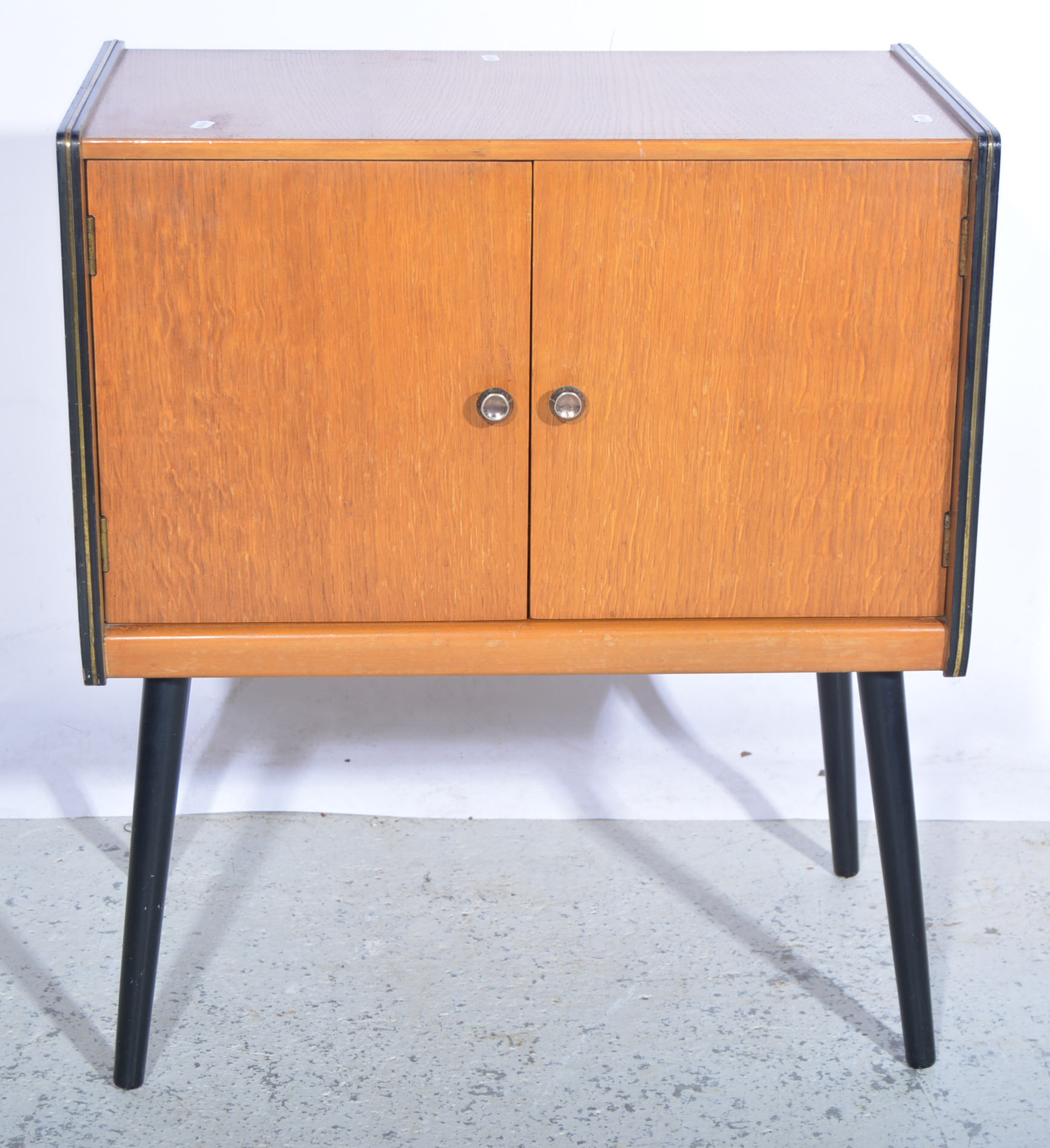 Homeworthy teak two-door record cabinet, ebonised and gilt outline,