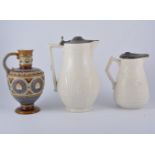 Two Victorian salt glaze ewers and a Mettlach ewer.