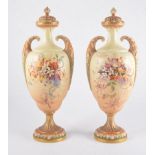 A pair of Royal Worcester twin handled pedestal vases with covers,