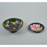 Small Moorcroft pedestal bowl, Hibiscus pattern, diameter 14cm; and a small blue ground dish, 12cm.