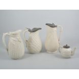 Three salt glazed stoneware jugs and similar teapot,