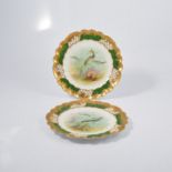 Pair of George Jones china cabinet plates, painted with mackerel and cod, green and gilt border,