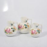 Three Victorian Staffordshire graduated jugs, handpainted with roses.