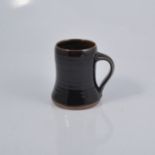 Harry and May Davis at Crowan Pottery, a studio pottery tankard, tenmoku glaze, impressed seal mark,