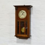 Stained wood wall clock, silvered dial, chain driven movement striking on a gong,