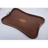 A mahogany twin handled tea tray, concave with contrasting vertical veneer,