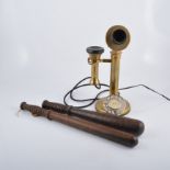 Three vintage style brass candlestick telephones, 87cm and smaller and two wooden truncheons, (5).